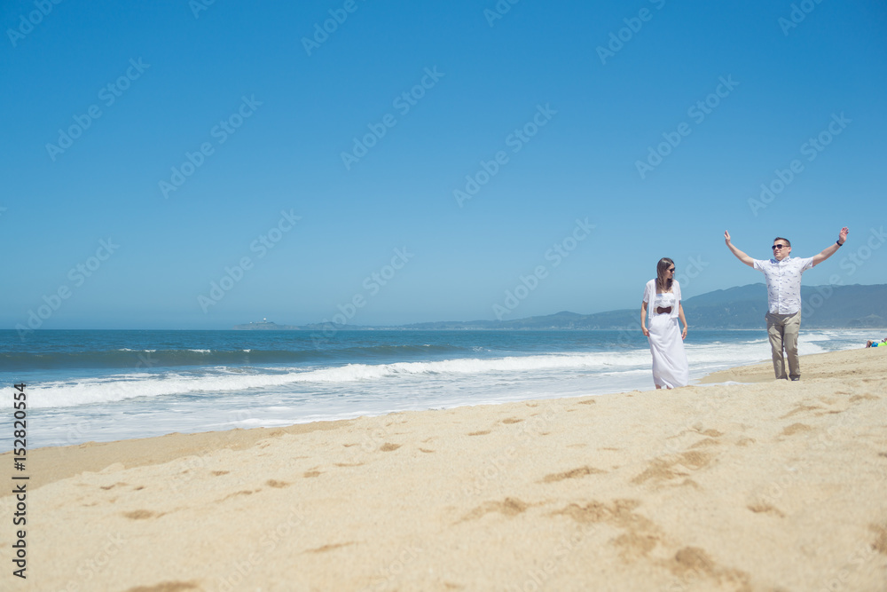 Young romantic couple walking on the beach Young romantic couple walking on the beach