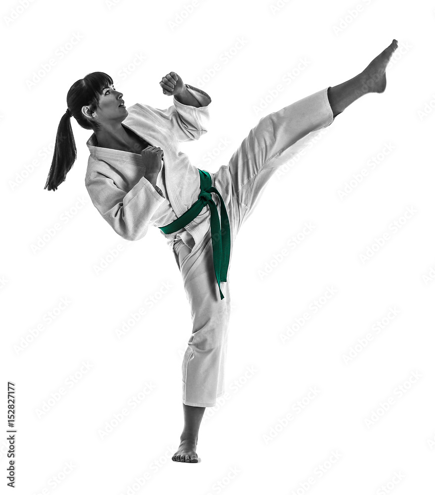Young sporty woman practicing martial arts on white background Young sporty woman practicing martial arts on white background