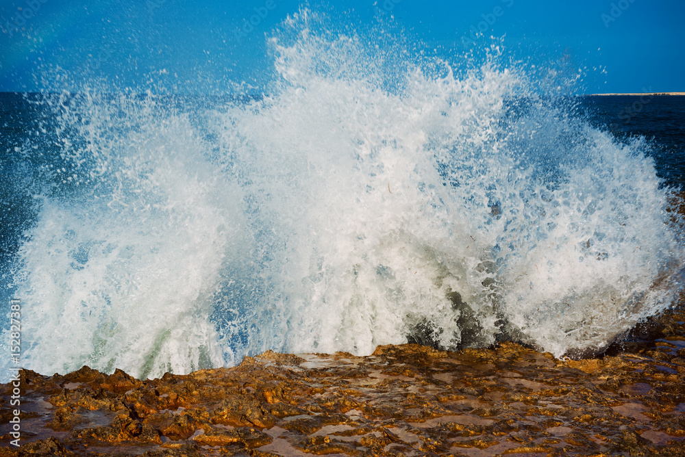 Obraz premium Sea wave splashing on rocks, natural holiday vintage hipster seasonal background