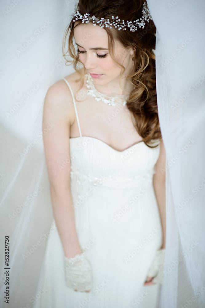 Brunette bride in fashion white wedding dress with makeup Brunette bride in fashion white wedding dress with makeup