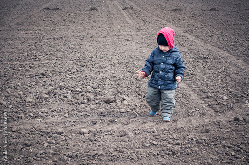The child goes on a field for crops
