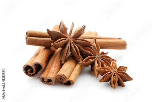 Cinnamon sticks with anise stars isolated on white  closeup