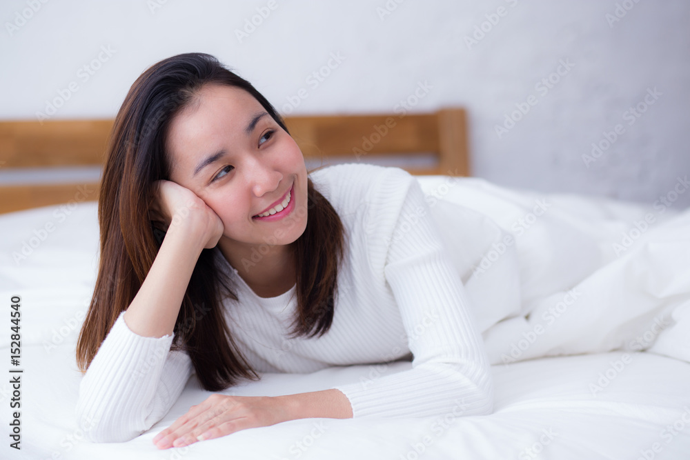 woman beautiful smiling woman portrait wake up early morning after sleeping and lying in bed. woman beautiful smiling woman portrait wake up early morning after sleeping and lying in bed.