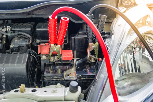 Charging car battery with electricity trough jumper cables,red and black Jumper cables