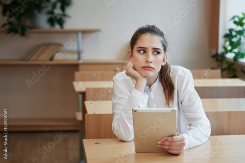 education and school concept - beautiful teenage girl in class