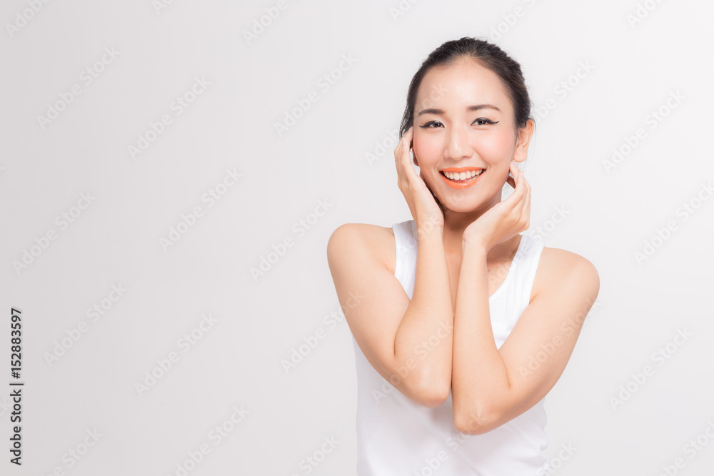 Beautiful Asian women stroking her pretty face with copy space Beautiful Asian women stroking her pretty face with copy space