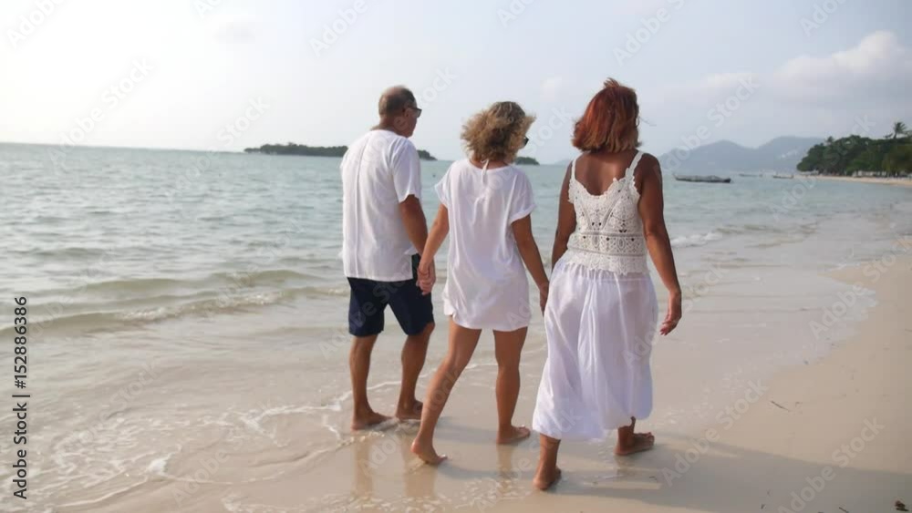 Happy Family: Daughter With Senior Parents Walking On Beach on Vacation. Slow Motion. HD; 1920x1080. Happy Family: Daughter With Senior Parents Walking On Beach on Vacation. Slow Motion. HD; 1920x1080.