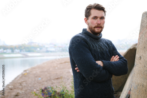 Handsome bearded man on the background of the river
