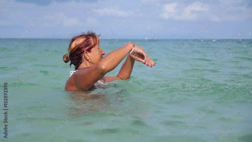 Happy Senior Woman Swimming in Sea on Summer Vacation. Slow Motion. HD, 1920x1080. Happy Senior Woman Swimming in Sea on Summer Vacation. Slow Motion. HD, 1920x1080.