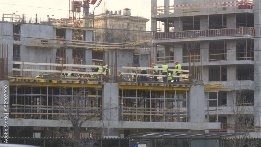 Construction site in the evening. The brigade makes the embedded elements of metal structures. Construction site in the evening. The brigade makes the embedded elements of metal structures.