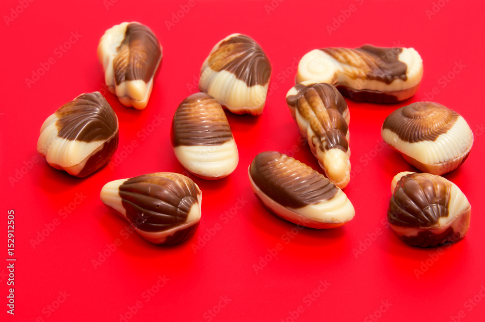 Chocolate candies isolated on red background. Chocolate candies isolated on red background.