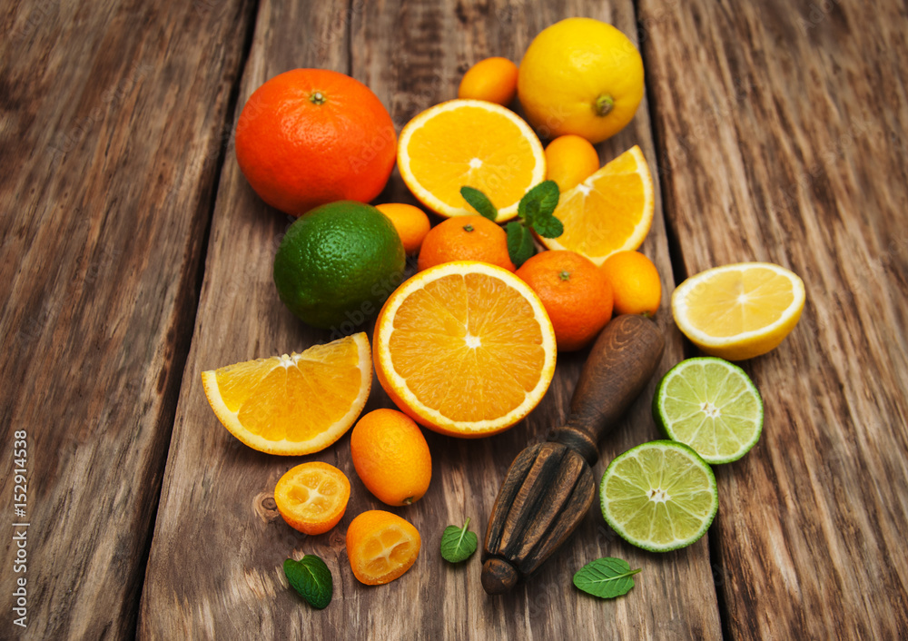 Fresh citrus fruits and old juicer Fresh citrus fruits and old juicer