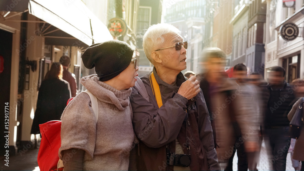 Asian senior couple lost in Europe. Travel after retirement and get confuse during the trip