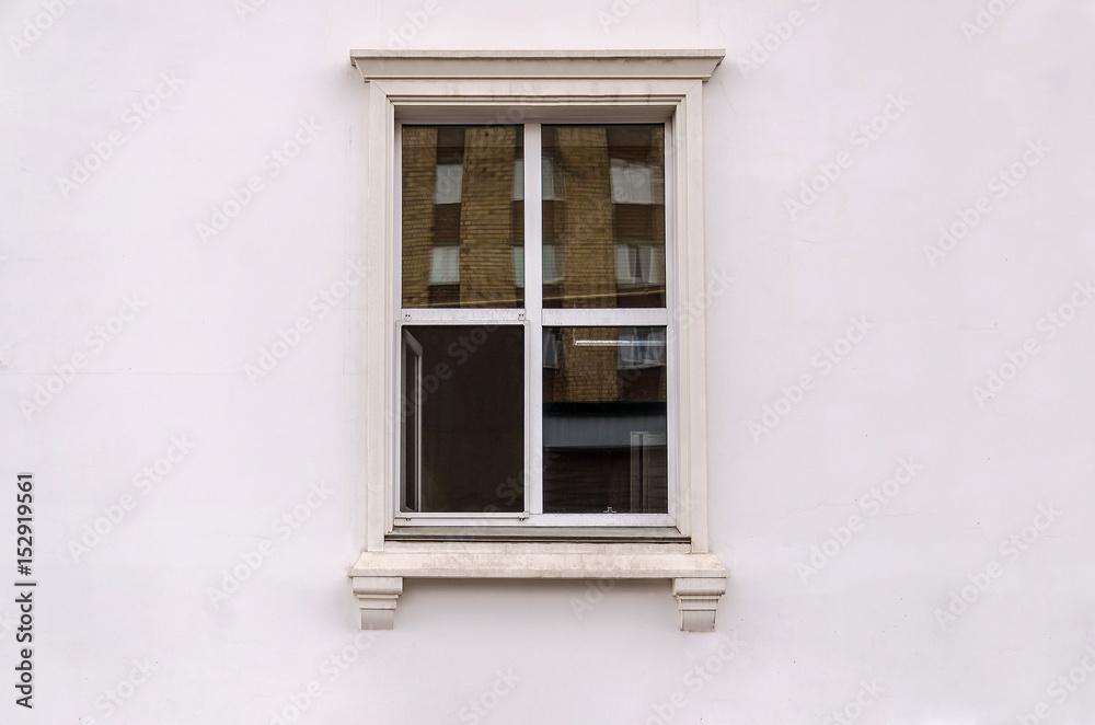 Beautiful window on white plaster wall