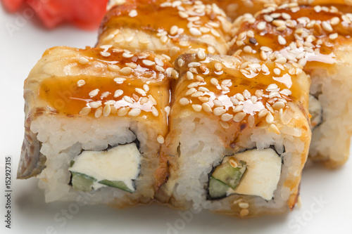 delicious rolls with eel and ginger on a white plate in a restaurant