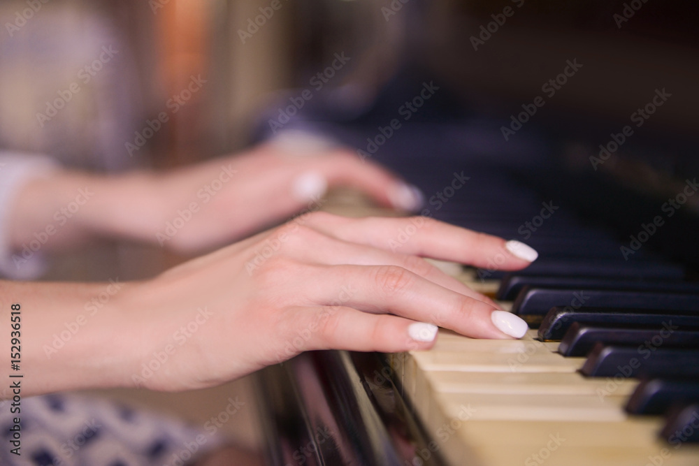 Female hands playing piano