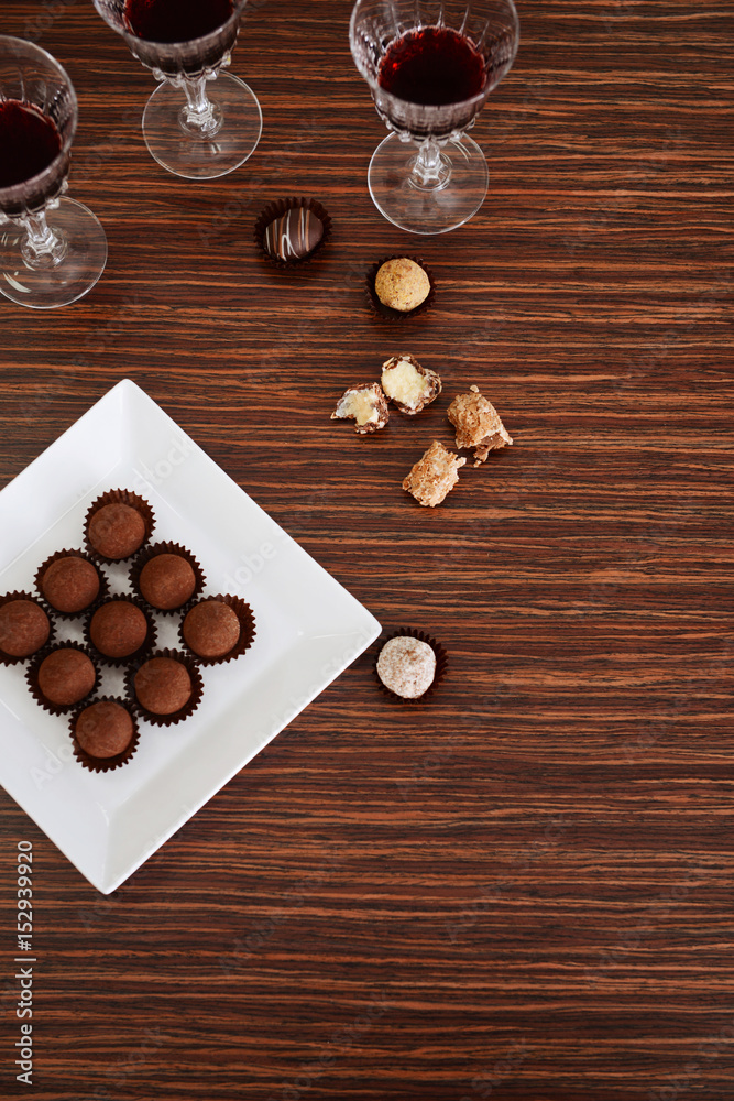 Wine and chocolates on wooden background Wine and chocolates on wooden background