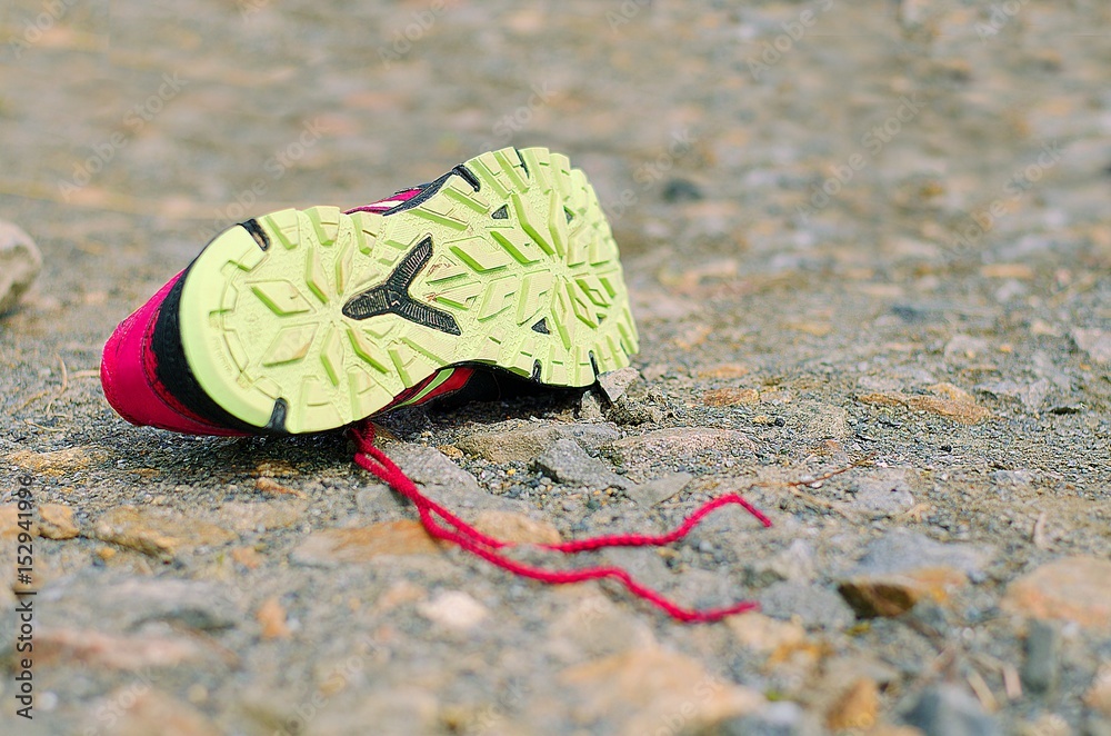 Lost running shoe. Tread of running shoe on rough sourface. Running concept. Lost running shoe. Tread of running shoe on rough sourface. Running concept.