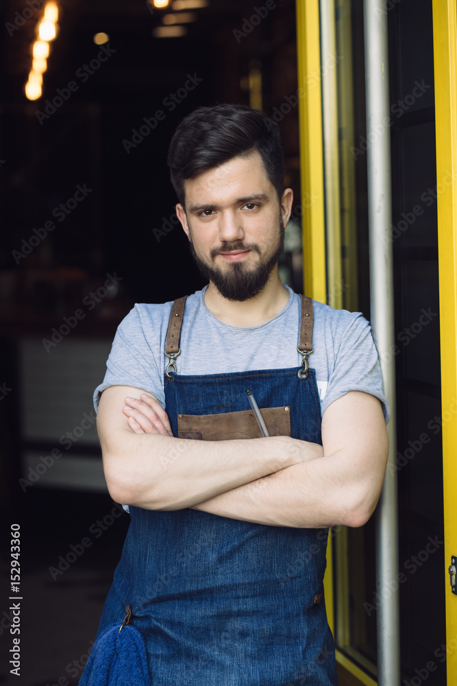 Bartender standing at a door of bar Bartender standing at a door of bar