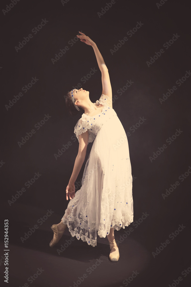 Fototapeta premium Young beautiful ballerina on dark background