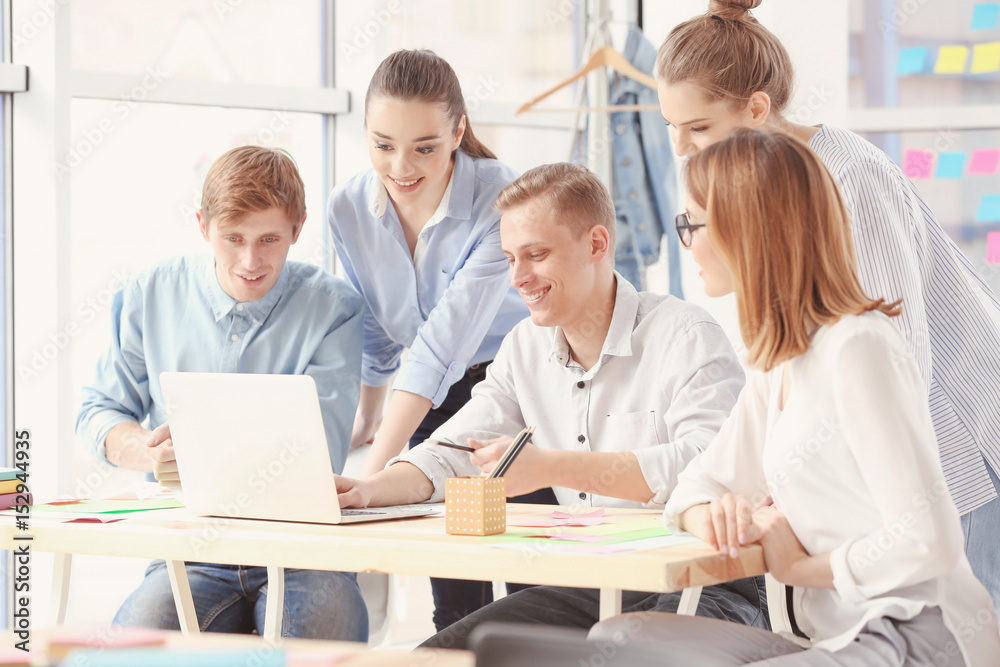 Team of young marketing managers discussing issues in office