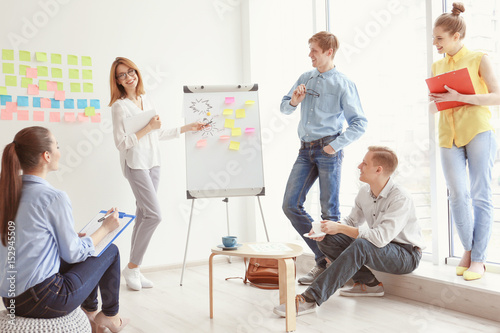 Young woman making presentation in office