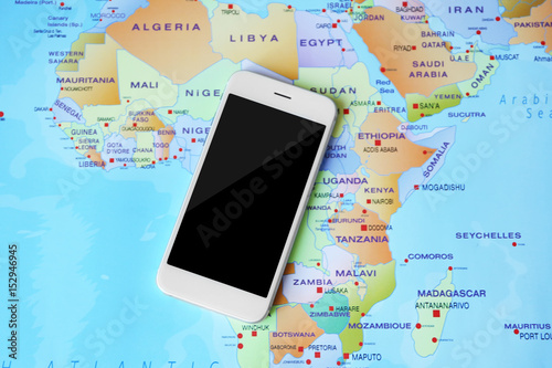 Smartphone on world map bac...
