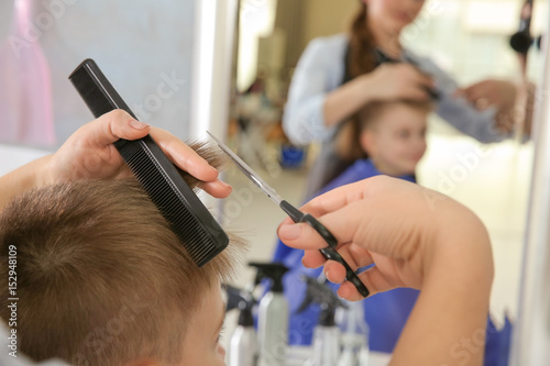 Cute little boy in hairdres...