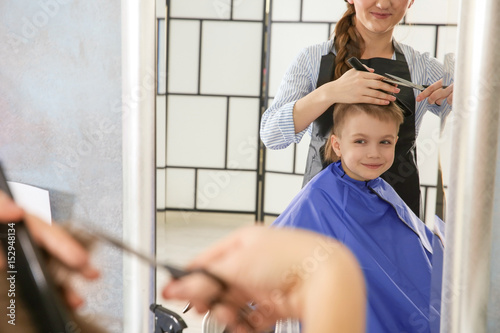 Cute little boy in hairdres...
