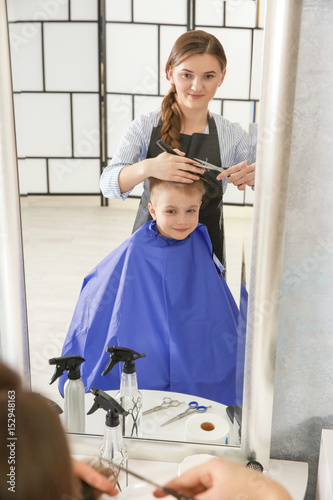 Cute little boy in hairdres...