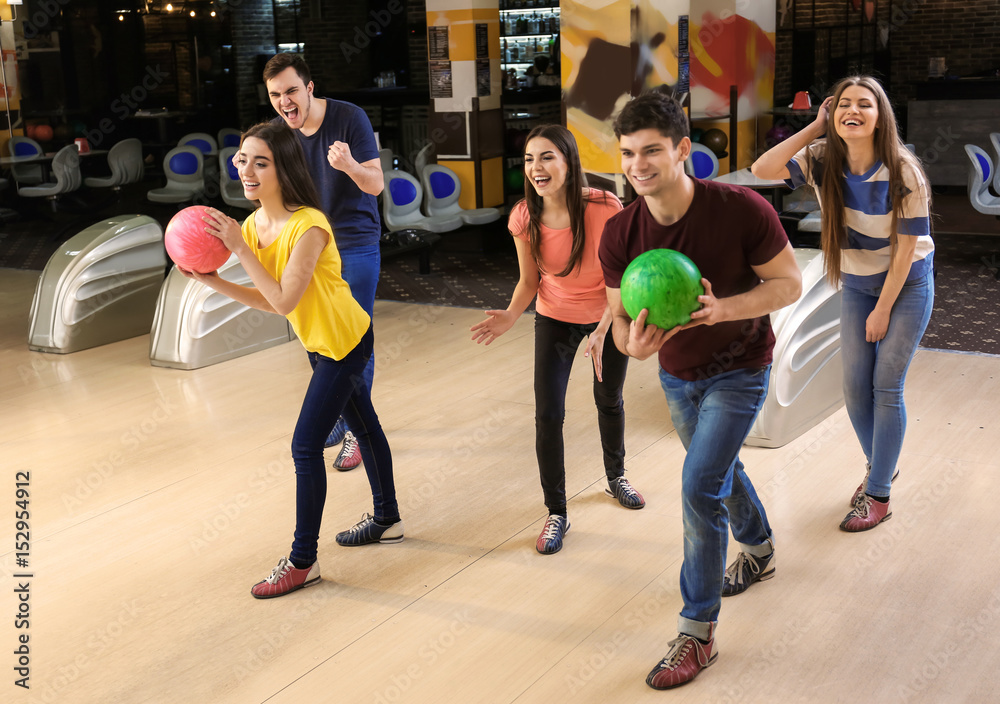 Fototapeta premium Friends having fun at bowling club