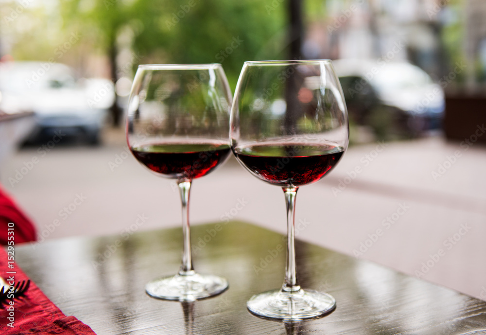 Two glasses with red wine in a cafe