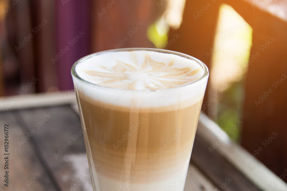 hot coffee latte art with glass on wooden table. hot coffee latte art with glass on wooden table.