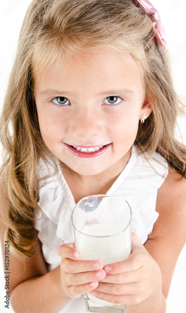 Smiling little girl drinking milk isolated Smiling little girl drinking milk isolated
