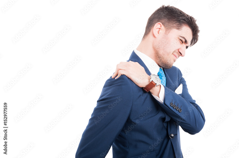 Young attractive man having shoulder pain after a stressful day on white background with copy space Young attractive man having shoulder pain after a stressful day on white background with copy space
