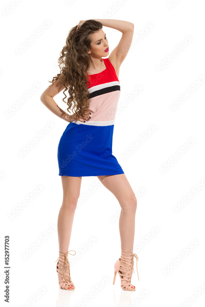 Fashion Model In Mini Dress Is Posing With Hand On Head Fashion Model In Mini Dress Is Posing With Hand On Head