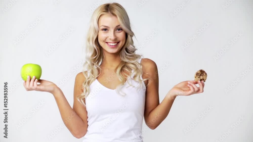 happy young woman with green apple and cookie happy young woman with green apple and cookie