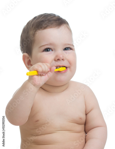 Cute child brushing teeth and smile, isolated over white.