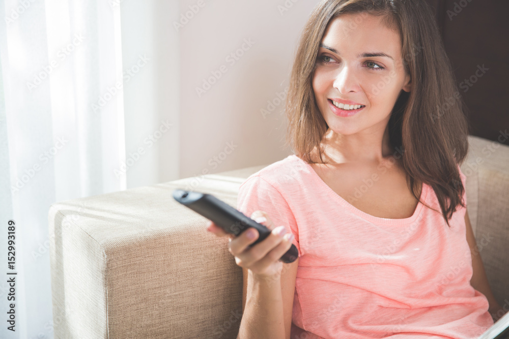 woman holding remote control for television woman holding remote control for television