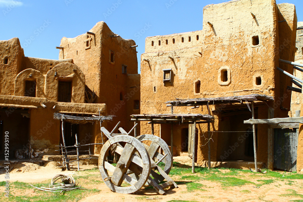 Old clay mongol city - buildings and wheeled cart