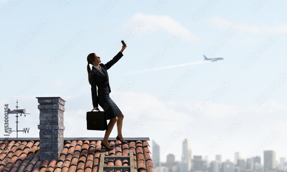 Businesswoman catching moment on her mobile Businesswoman catching moment on her mobile