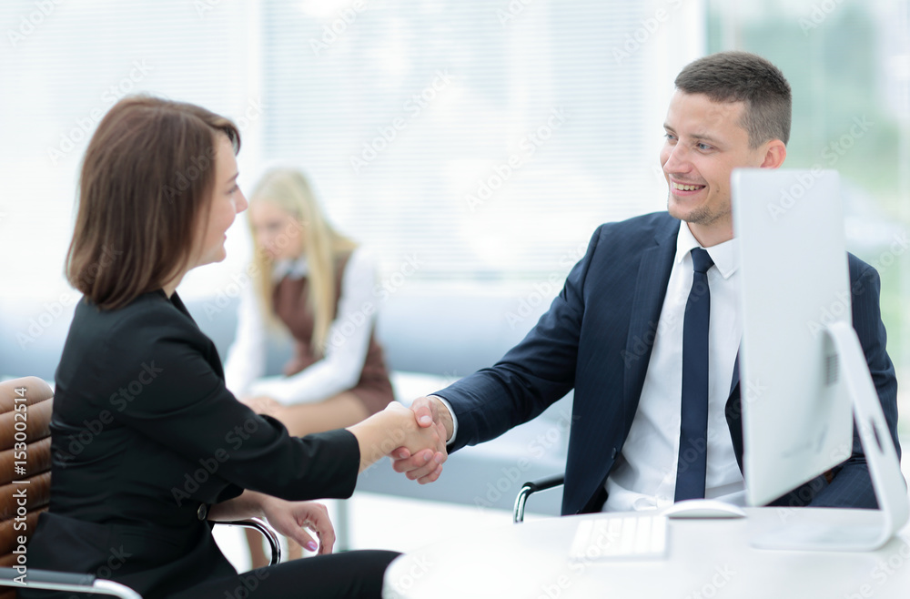 Business handshake. Two business people shaking hands in office.