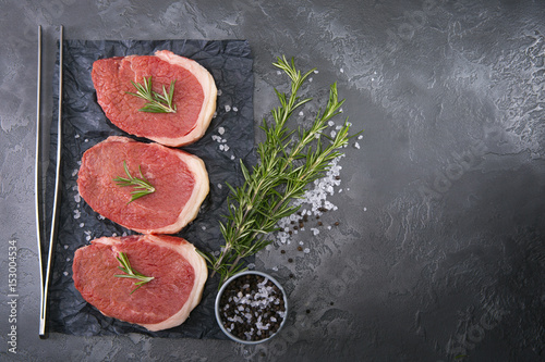 Meat for cooking steak, on a marble background.