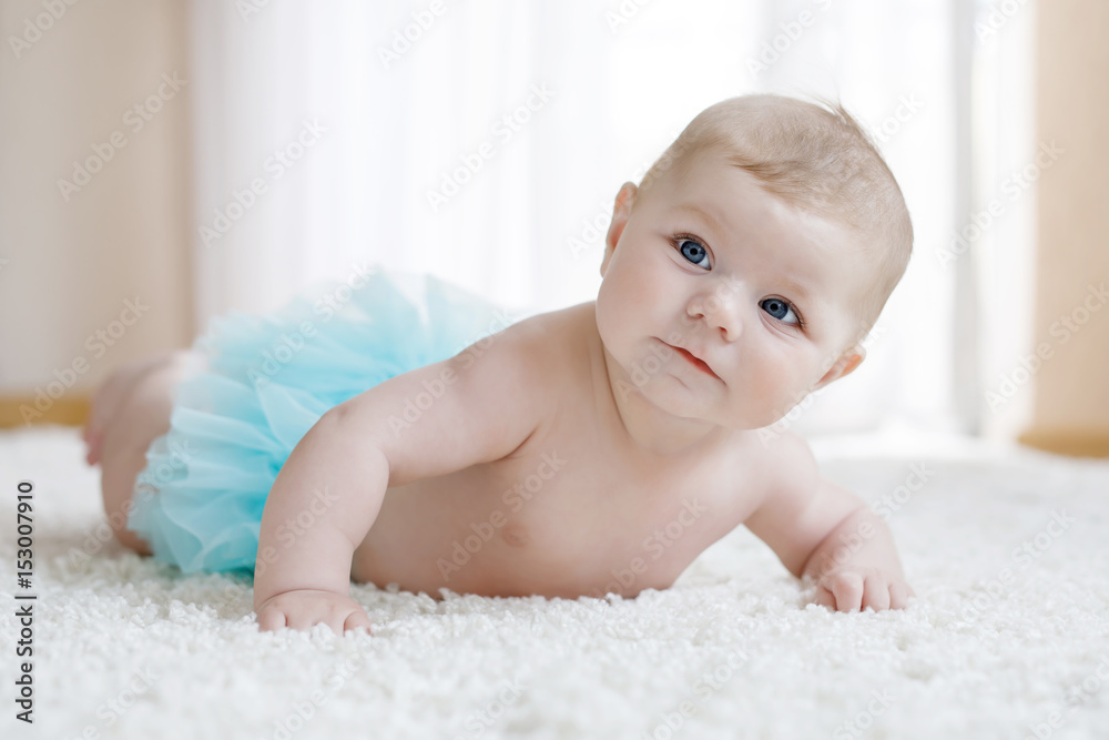 Adorable baby girl on white background wearing turquoise tutu skirt. Adorable baby girl on white background wearing turquoise tutu skirt.