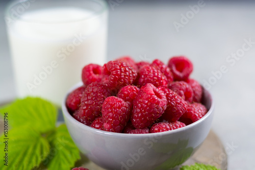 Fresh cow milk and ripe organic red raspberry