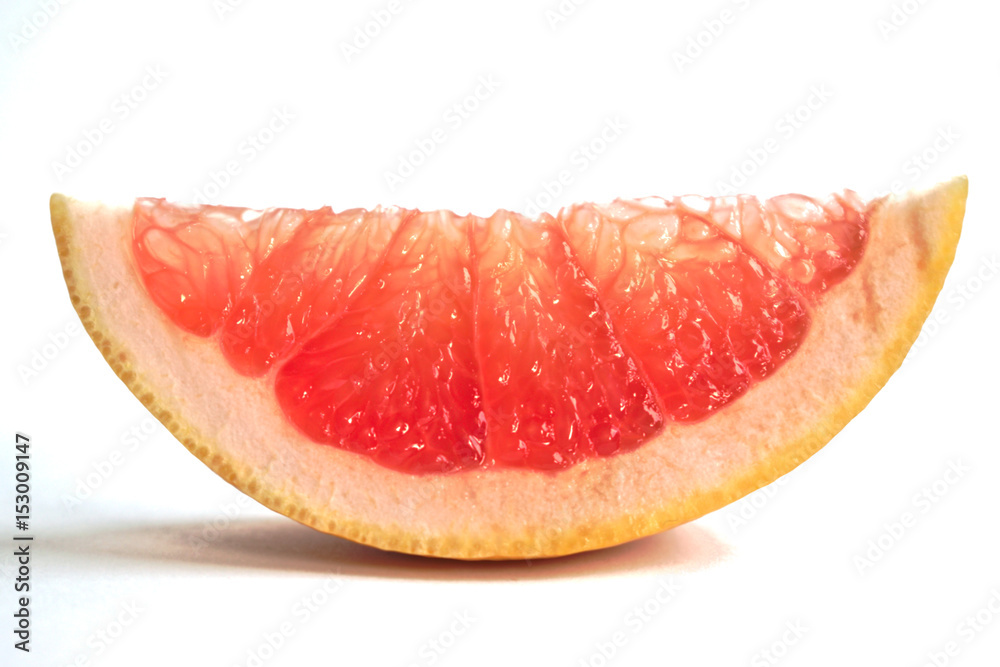 Closeup of a grapefruit wedge on a white background Closeup of a grapefruit wedge on a white background
