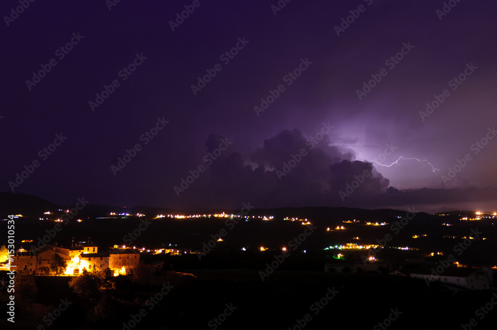 Fototapeta premium Thunderstorm and lighting behind the clouds