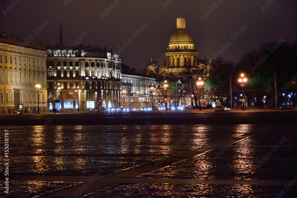 St. Isaac's illuminated Cathedral from the Palace square at night in the rain. Saint Petersburg