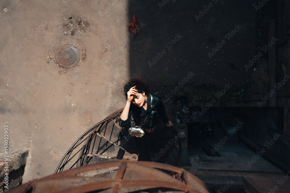 Girl posing on a spiral staircase Girl posing on a spiral staircase
