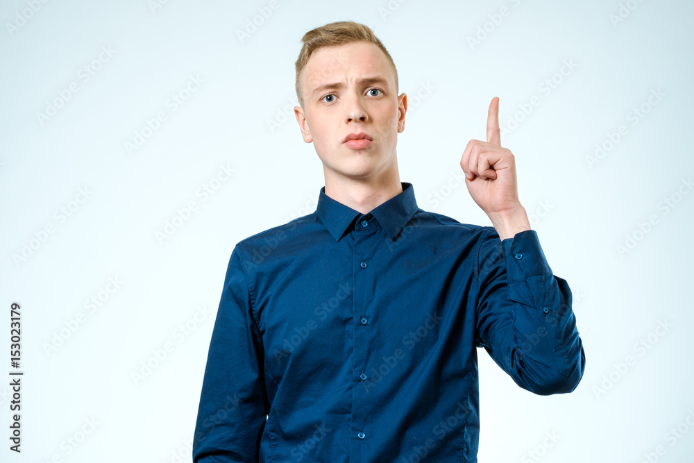 Attractive man showing his forefinger. Good idea or attention gesture Attractive man showing his forefinger. Good idea or attention gesture